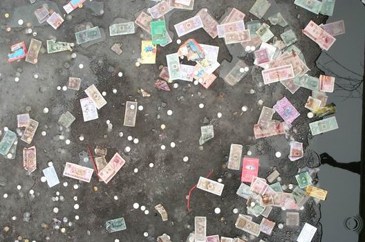 In China people have a strange idea of throwing money at things. In The Forbidden City they throwed money in a small pond and this was the result. I hope it means luck or something. In think it looks like pollution!