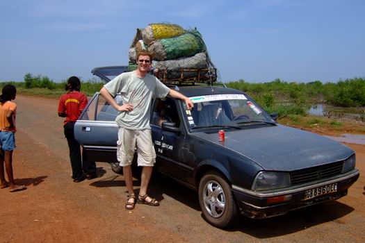 Me, a Peugeot 505 and a bunch of coal waiting for a ferry that will sail us (all) to the other embankment of the river "Rio de Canjambari". Actually the river was not very wide and the ferry could easily be substituted by a bridge. Our driver told us that Portugal had promised to finance a bridge.